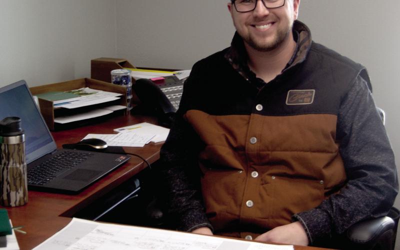 Cherokee County Ag and Natural Resource Agent Clayton Jester sits behind his desk at the K-State Research and Extension office in Columbus.