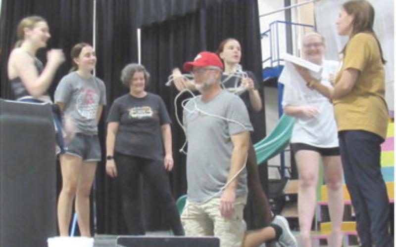 Cast members of 9 to 5: The Musical, rehearse a scene. Actors include ladies left to right: Khloee Cox, Mallory Thompson, Michelle Atchley, Madalyn Weeks, Kaylee Denton and choreographer Melissa Thompson-Holt. Center Chad Fletcher in the role of Franklin Hart. Courtesy photo.