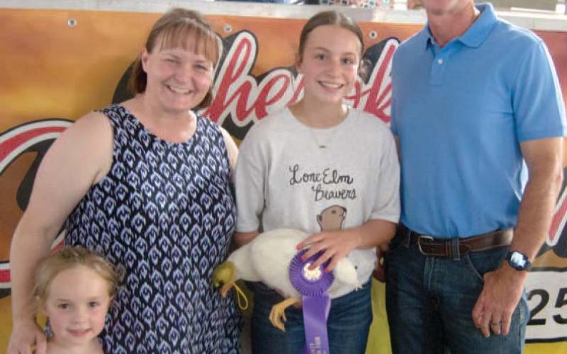 Lone Elm Beavers 4-H Club member Kinsley Hess, daughter of Travis and Amanda Hess showed the Grand Champion chicken and received $1,400 in premium from American Bank.