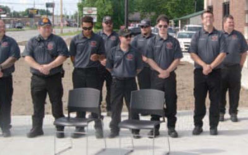 The Baxter Springs Fire Fighters surrounded Mayor Kelly Abbott at the ribbon cutting officially opening the new fire station and retiring the 99 year old station on Eleventh Street.