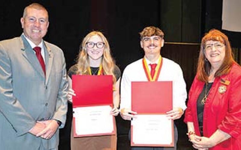 Teacher of Promise awards were presented to Columbus High School graduate Jaxson Haraughty (center) and Mia (Anderson) Beebe of Spring Hill during ceremonies at the Bicknell Family Center for the Arts. The awards were presented by Associate Dean Jason Clemensen (at left) and Jean Dockers, director of the teacher education program at Pitt State (at right).