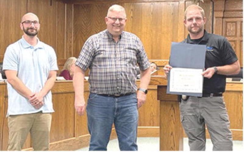 At the Monday night Columbus City Council meeting, Chief of Police Kyle Clark (at right) was presented a certificate of recognition for his five years working with the City. Presenting the award were Jake Letner, City Administrator and Grant Spieth, Mayor.