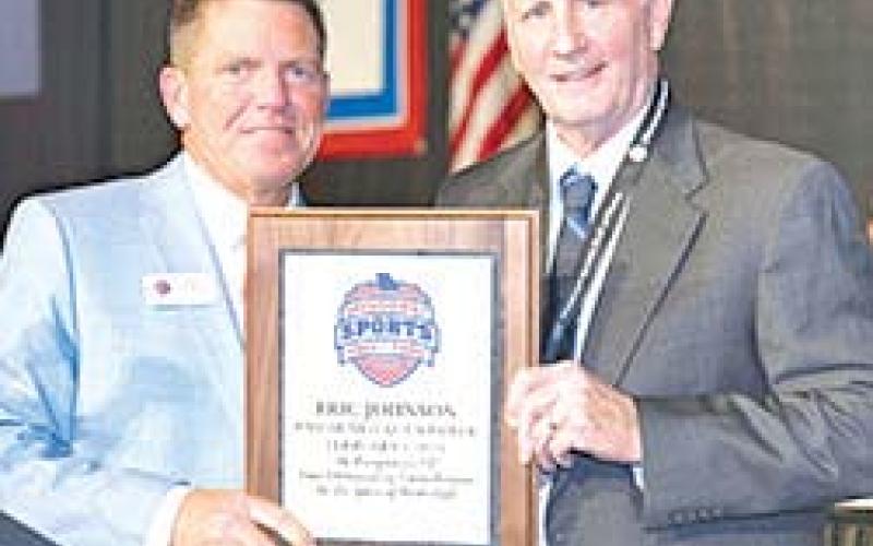 Former Columbus Titan Basketball Coach, Eric Johnson, was enshrined into the Missouri Sports Hall of Fame, in a ceremony February 1 with the Class of 2026. He received a commemorative plaque from Bob Marsh, President and CEO of the Hall of Fame during ceremonies in Springfield, Mo. Photo courtesy of Miles Boyer Photography.