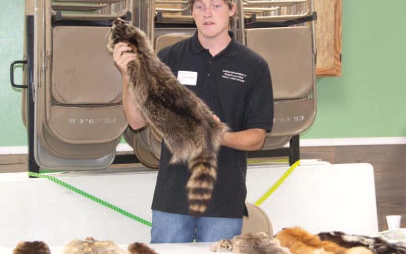 Kansas Department of Wildlife and Parks Public Lands Division, Monte Schroeder, shows students some of the different wildlife found throughout Kansas. He discussed their appearance, habitat and where they are commonly found throughout the state. News Report photo by Tanya Woolsey.
