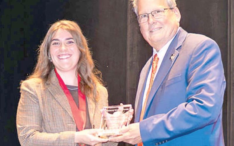 Kate Tyree, 2020 Riverton High School graduate was named Pittsburg State University student employee of the year. PSU President Thomas Newsom presented the award. Courtesy photo.