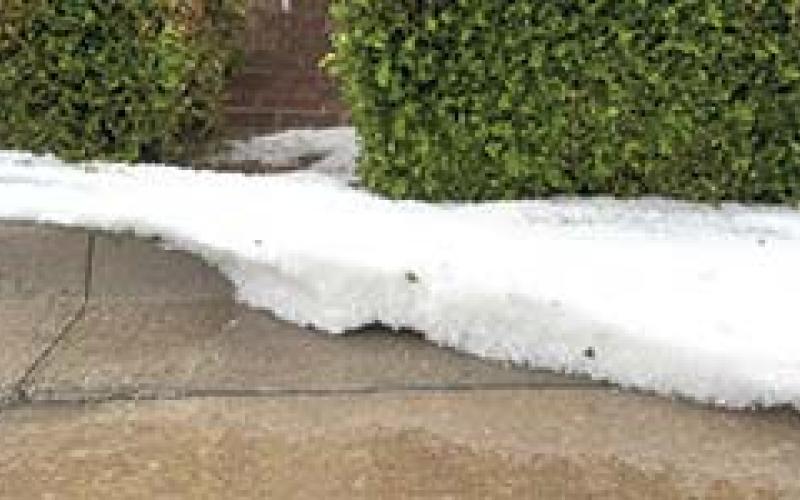 The storms Wednesday brought copious amounts of hail along with the rain. Gutters on the square were flowing with white masses of ice. Courtesy photo.