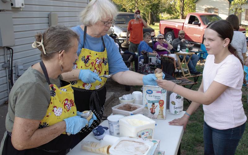 Lines formed for ice cream cones during the Annual Weir Homecoming BeanFeed September 18. Members of the Weir Senior Center offer free ice creamcones to those in attendance, youngster Emma Young was first in line to get a chocolate cone.