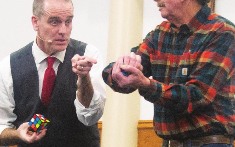 Magician and comedian Mike Bliss performs a magic trick with participant Terry Hilderbrand during Center Christian Church’s 24th annual Chili Feed event. Attendees were entertained by tricks including pick-pocketing, mind reading and unicycling. Photo by Jacob Spencer