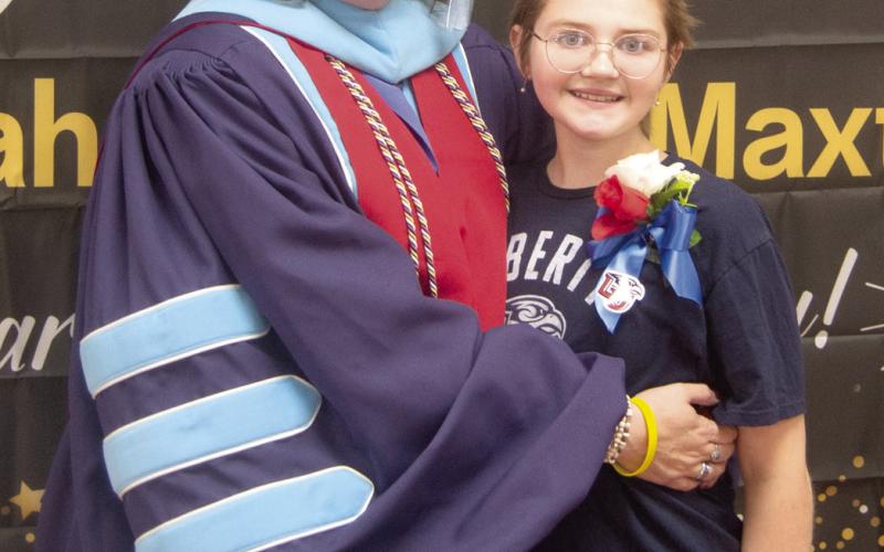 A reception for Dr. Sarah Garner Maxton was held recently (May 25) at the Baxter Springs Community Center. This has been quite a journey for the “high distinction” Liberty University graduate. All this while her daughter, Eva, was battling Ewing Sarcoma Cancer. Sarah was wearing her graduation robes with scholar accoutrements and her 4.0 Grade Point Average medal.