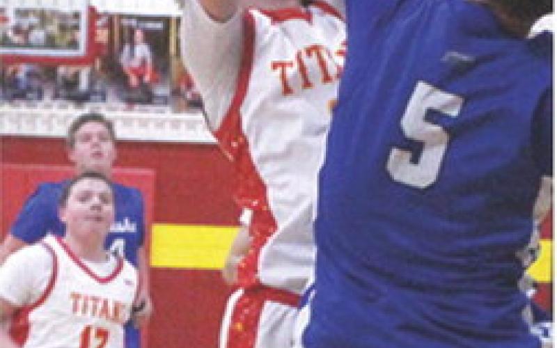 Titan Junior, Gavin DePratt, goes up for two against Neodesha Freshman, Tayte Leck, in the junior varsity loss, 37-62, at the Columbus Unified High School Gymnasium. Sophomore, Ethan Midgett, trails.
