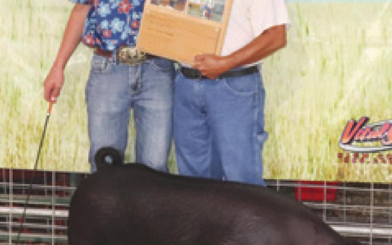 Cherokee County 4-H member Cole Youngblood was awarded the Buck Sharp Swine Award during the county fair. Anne Sharp presented the plaque. Youngblood was Grand Champion in Senior Fitting and Showing and Grand Champion in Market Hogs,