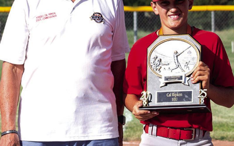 Briggs Johnson received the coveted Commissioner’s Attitude, Hustle, Hustle, Pride, (AHHP) at the Kansas Cal Ripken 10U State Tournament, July 20, in Hillsboro. Kansas Cal Ripken State Commissioner, Paul Unrau presented the trophy at the conclusion of the tournament. Photo by Kristin Sharp.