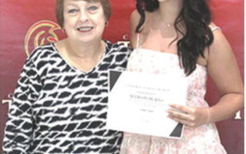 Allison Burns received the Coterie Scholarship in the amount of $250 during the CUHS Senior Assembly, May 16, from USD493 Instructor, Karen Langerot, at the Columbus High School Gymnasium.