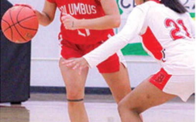 Lady Titan Sophomore, Americus Woodcock, drives past Lady Lion Sophomore, Faith Murray, in the January 16, Columbus win in Baxter Springs. Americus scored six points in the Lady Titan loss to Commerce, Okla. in the 2026 Lancer Classic opening round, Monday, 26-43.