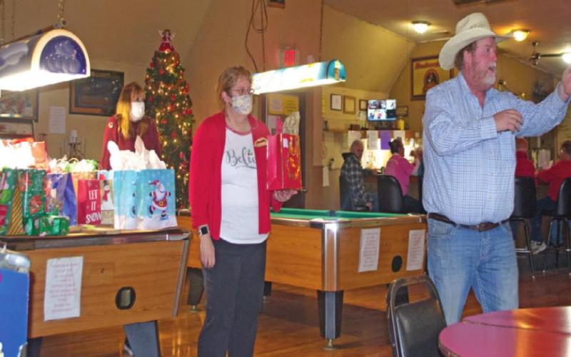 Auctioneer Phillip Bass works the crowd at the West Mineral Eagles Lodge into purchasing various bagged items as part of the fraternity’s fundraiser. Members bid on over 40 items throughout the afternoon, allowing the group to collect $1,161.50 to donate to various health organizations.