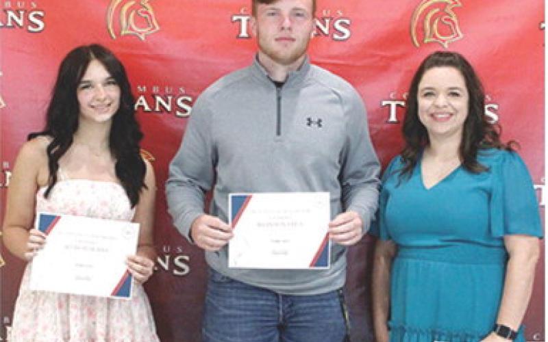 Allison Burns and Brandon Stice received the Columbus Junior, Senior High School Business Scholarship in the amount of $350 each from USD 493 Business Instructor, Laura Boeckman during the 2025 Senior Assembly, May 16, at the Columbus Unified High School Gymnasium.