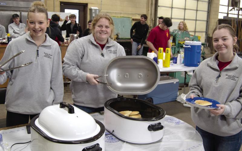 Serving pancakes and sausage Trinity Green