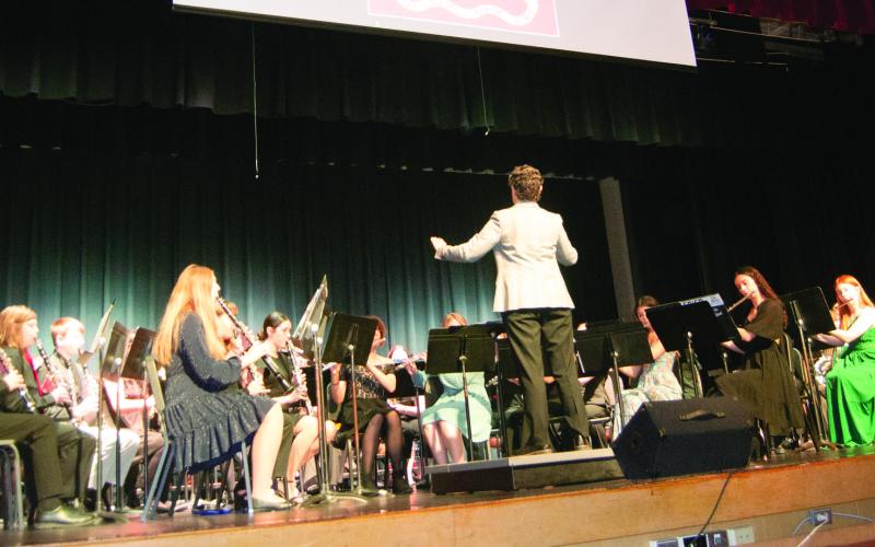The Columbus High school Band played the “Marches of the Armed Forces” as their flags appeared on the screen above the band.