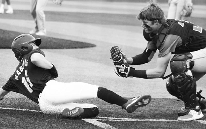 Titan Senior, Jace Midgett, tags out the Northwest Arkansas runner in the Saturday, Titan win, 14-4, over the Hornets in Wyandotte and Seneca High School’s Baseball Festival.