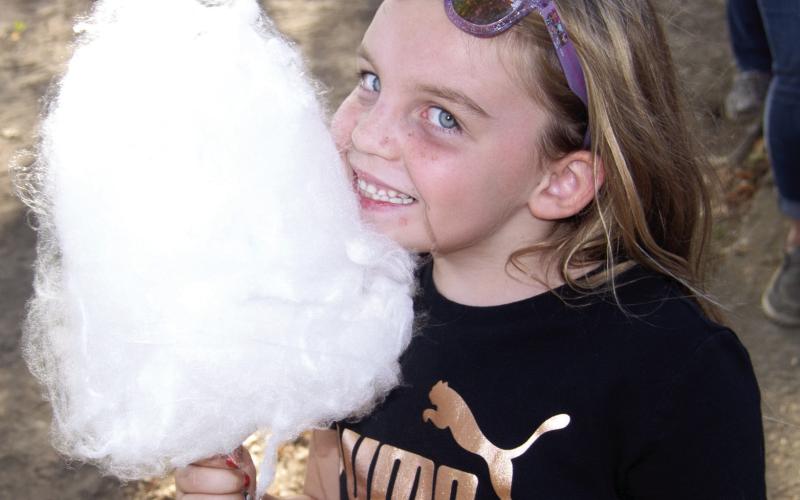 Nothing like cotton candy on a Saturday afternoon in Scammon says Evelyn Mays, 6, as she enjoys the candy.