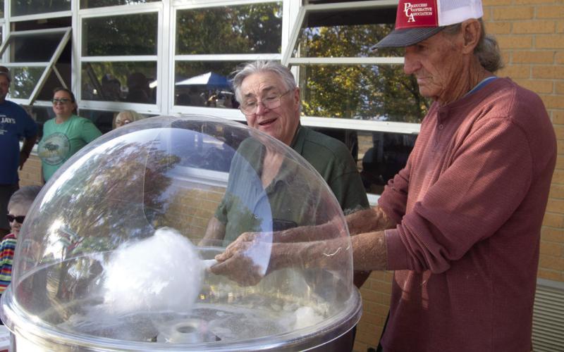 Steve Langerot and Marvin Eaton operated the cotton candy machine as the youngsters, and even some oldsters were lined up to get the sugary treat.