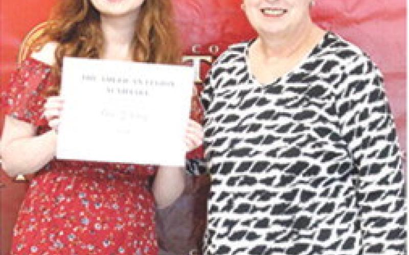 Senior Ava Hulvey, received the American Legion, Sunflower Girls State Scholarship for $250 from USD 493 Instructor, Karen Langerot, during the May 15, Senior Assembly at the Columbus High School Gym.