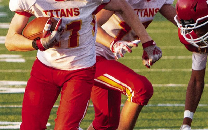 Elijah Shoemaker, Titan Seventh Grader, races toward the goal line with blocker, Hayden Kellogg on his heels. Elijah was just short of the goal line, in a 6-14 loss at Chanute, Thursday. Photo by Kristin Sharp.