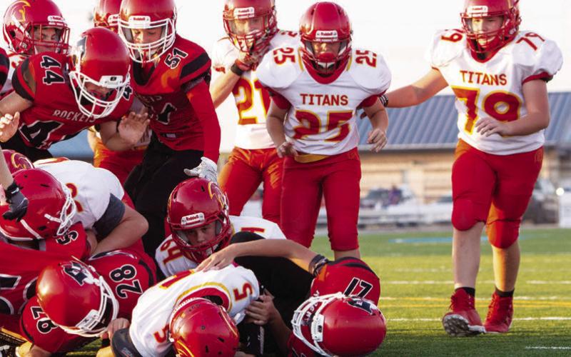 Number 5, Blaze Bowman, made a quarterback sneak across the goal line for the lone Titan Seventh Grade Touchdown, Thursday, in the 6-14, loss at Chanute. Elijah Shoemaker, Jax Sharp, Ethan Perdue, Brogan Hutto, and Cajen Smith can also be seen in the goal line push. Photo by Kristin Sharp.
