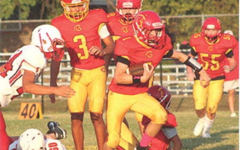 Denver Hughes, Titan Eighth Grader, breaks through the line and scores on an 11-yard run to the end zone. Columbus beat the Baxter Springs Lions, 32-0, Thursday at Titan Stadium. Jayden Dohle, Jex Cheney, Thomas Bidwell, and Will Weber can also be seen in action.