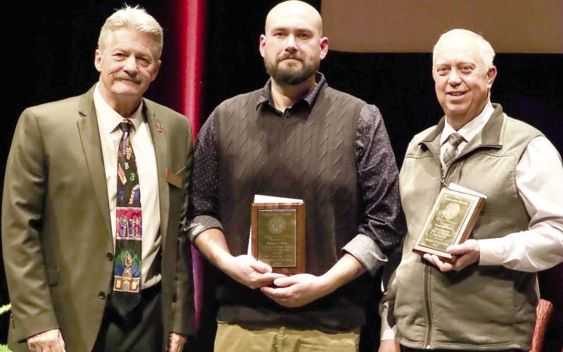 The PSU College of Education honored veteran administrator an accomplished teacher Dr. Brad Miner, (right) Superintendent at USD 247 in Cherokee with the Distinguished Service Award. In addition to Dr. Miner, Shawn LaSota (center) an English language teacher in Erie received the recognition. The awards were presented by Dean John Opplinger. Courtesy photo.