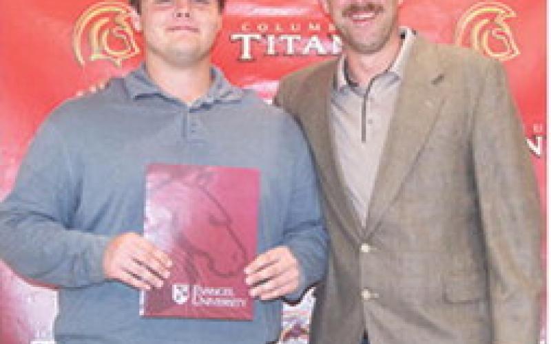 Carter Henry received three scholarships from Evangel University during the Columbus Unified High School Senior Assembly, May 16, at the CUHS Gymnasium. He received a $14,000 Academic Scholarship, a $3,000 Football Scholarship, and a $1,000 Sibling Scholarship from presenter, Matt Crain, USD 493 Instructor.