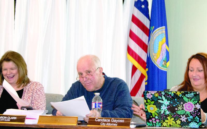 Newly sworn-in Mayor Kelly Abbott took his place at the end of Tuesday’s City Council meeting. He is between City Clerk Sharon Clark and City Attorney Candace Gayoso.