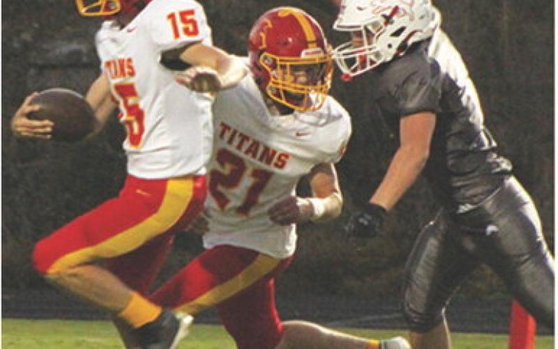 Junior, Shade Schuberger, has the back of freshman, Denver Hughes, following a blocked punt Hughes picked up and ran in for six points to put the Titans on the scoreboard first. Sophomore, Brody Carter, blocked the kick and senior, Zane Gray kicked the point-after-touchdown for a 7-0 Columbus lead midway through the first quarter in the 15-14 Titan win Friday night in Baxter Springs.