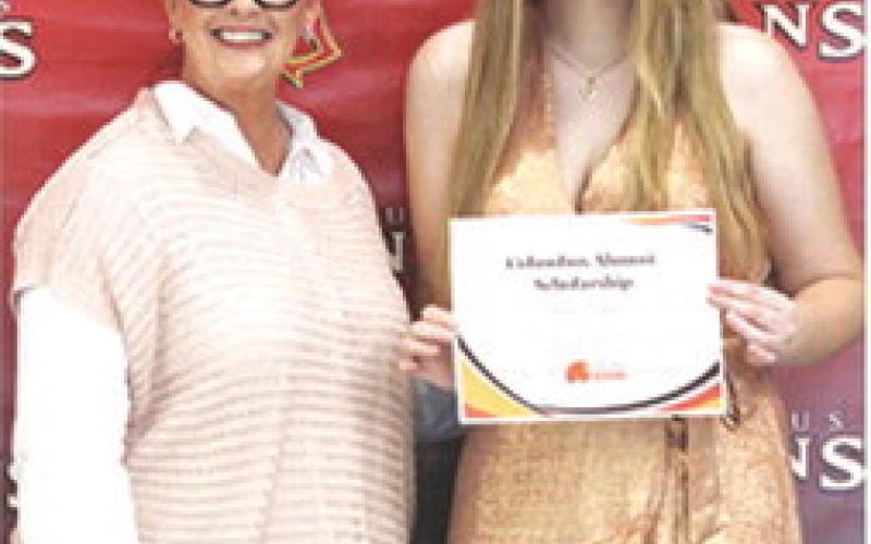 Anna Head received a $1,200 Columbus Alumni Scholarship from Rebecca Spooner, at the 2025 Senior Assembly, May 16, at the Columbus Unified High School.