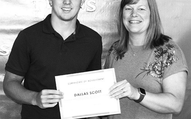 CUHS Senior Dallas Scott received a Crossland Kickstart Scholarship presented by Crossland representative Misty Spear at the Senior Awards Ceremony held May 17 at the Columbus Unified High School gymnasium.