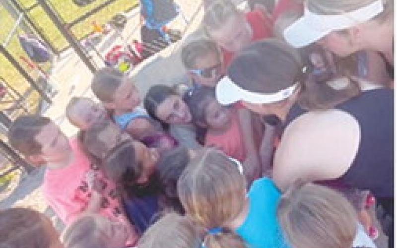 A post practice team huddle following the first day of the 8U softball clinic results in a “Go Lady Titans” cheer. Courtesy photo.