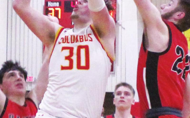 Titan Junior, Brett Hamilton, drives the lane for two points in the 50-31, Sub-State win over Baxter Springs, Monday at the CUHS Gymnasium. Brett led the scoring with 16 points. Defending for the Lions are senior, Kaden Niday and senior, Garrett Paxson. Sophomore, Payton Gaines, can also be seen.