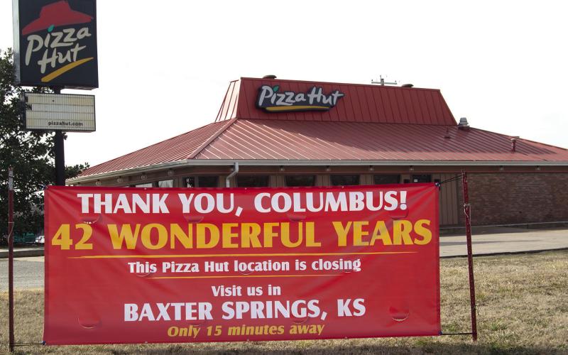 A sign stands in front of the former Columbus Pizza Hut announcing their closure. After 42 years the restaurant was closed abruptly Sunday. News Report photo by Tanya Woolsey.