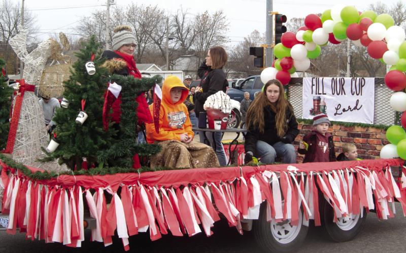 Several businesses, including Punkins Place, entered floats in the Baxter Springs Christmas parade. In addition to a large cup of coffee, the float was adorned by colorful balloons and streamers.