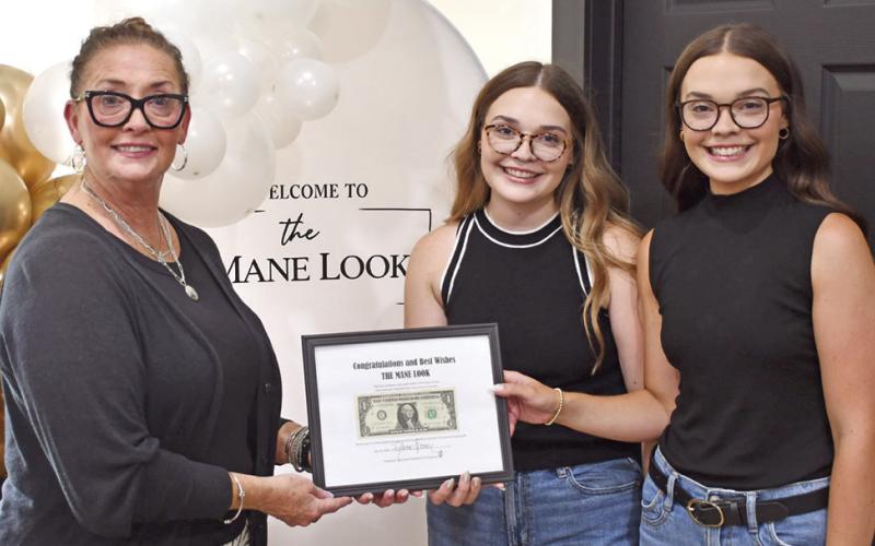 A ribbon cutting and presentation of the first dollar was held at the newest hair salon in Columbus. The Mane Look, was built from the ground up by Columbus High School Alums Hayden and Peyton Allen. They were presented their first dollar (at right) by Rebecca Spooner, Columbus Chamber of Commerce President.