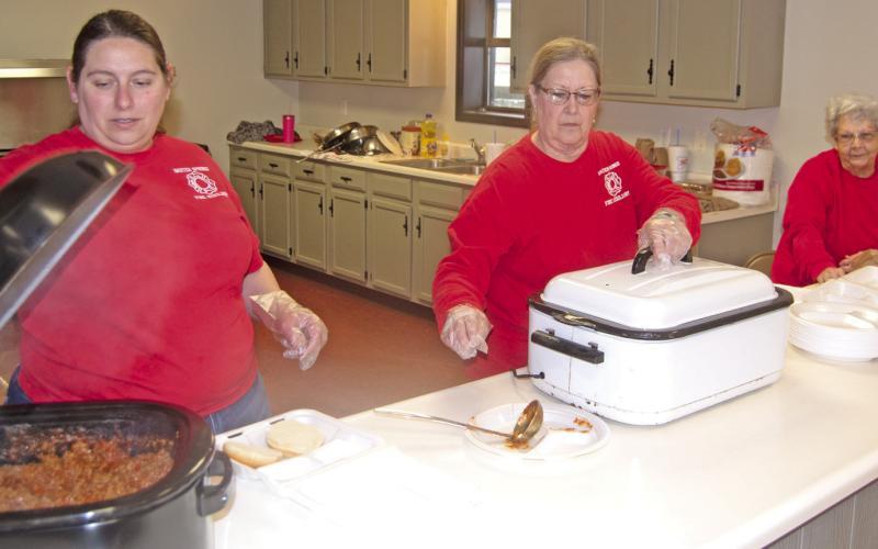 Baxter Springs Fire Auxiliary recently held a sloppy Joe fundraiser to raise money for the Baxter Springs Fire Department. Among those working were Rachel Shepard, Debbie Page and Sue Landreth.