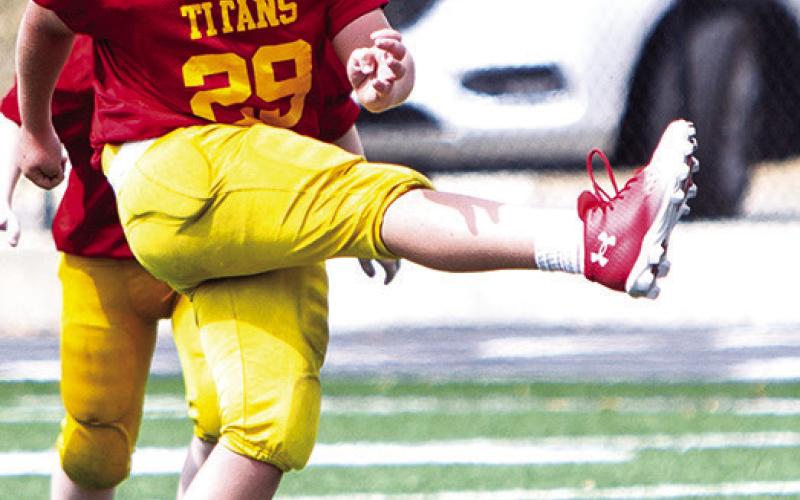 Kayden Fleshman kicked off for the Columbus Titan Fifth/Sixth Grade Titans in their win over Pittsburg Woods, 20-6, September 21, in Pittsburg. Photo by Kristin Sharp.