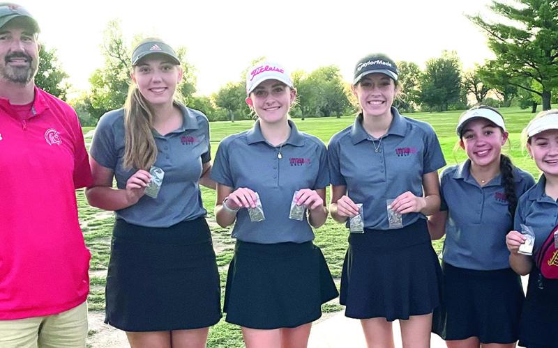 The Columbus Unified High School Lady Titan Golf Team took first place in the Uniontown Invitational, at Woodland Hills Golf Course in Fort Scott, Monday. Head Coach Dan Grundy is pictured with Anna Head, Mallory Thompson, Natalie Wary, Hannah Noel, and Amory Neely following the presentation of medals. Thompson was the top medalist to help her team slip past Caney Valley for the team win. Courtesy photo.