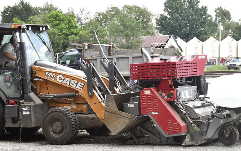 City of Columbus crews have been working to grind streets ahead of planned resurfacing later this fall. The new milling machine, shown attached to one of the city’s backhoes, has experienced issues in recent weeks resulting in its temporary retirement. City Superintendent Randy Coble expects it to be back to work in the coming weeks.