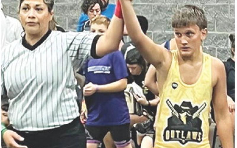 Briggs Johnson has his arm raised in victory following a match in the Cowboy Rumble at Branson, Mo., August 2-3. Courtesy photo.