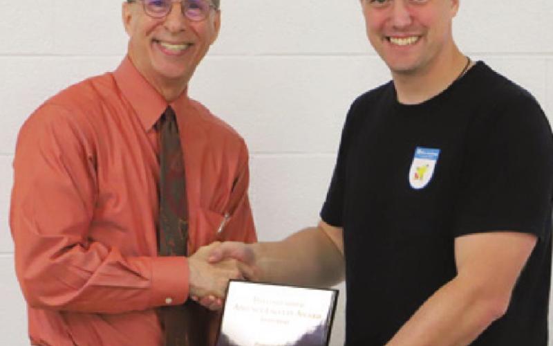 Luke Henke (right), Columbus High School teacher has been awarded the Adjunct Faculty Member of the Year award at Labette Community College. The award was presented by LCC President Mark Watkins.