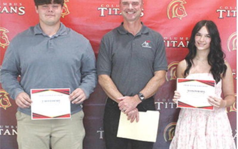 Carter Henry and Allison Burns each received a $1,000 American Bank Scholarship from bank president, Jim Gaither, during the 2025 Columbus Unified High School Senior Assembly, May 16 at the CUHS Gymnasium.