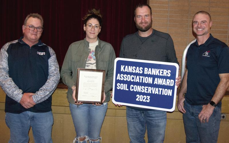 The Banker’s Award was presented to Nick and Emily Smith by Carl Mussa, (left) Soil and Water Conservation Chairman an Jim Gaither, County Key Banker, (right).