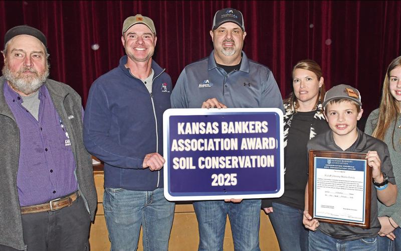 At the Soil and Water Conservation meeting Monday, Nick and Christina Martin and their children Karsten and Kate were presented with the 2025 Kansas Bankers Association Award for Soil Conservation. Mark Epler and Jim Gaither presented the award.