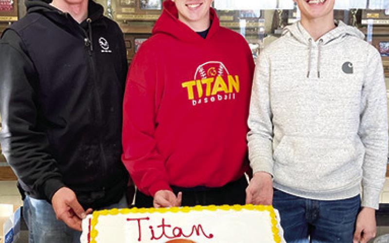 Titan Seniors, Cole Youngblood, Huck Hallam, and Derek Krause were celebrated with a special cake at the CUHS Boys Basketball Banquet, Monday, at the Columbus High School Gymnasium Lobby. (Courtesy Photo.)
